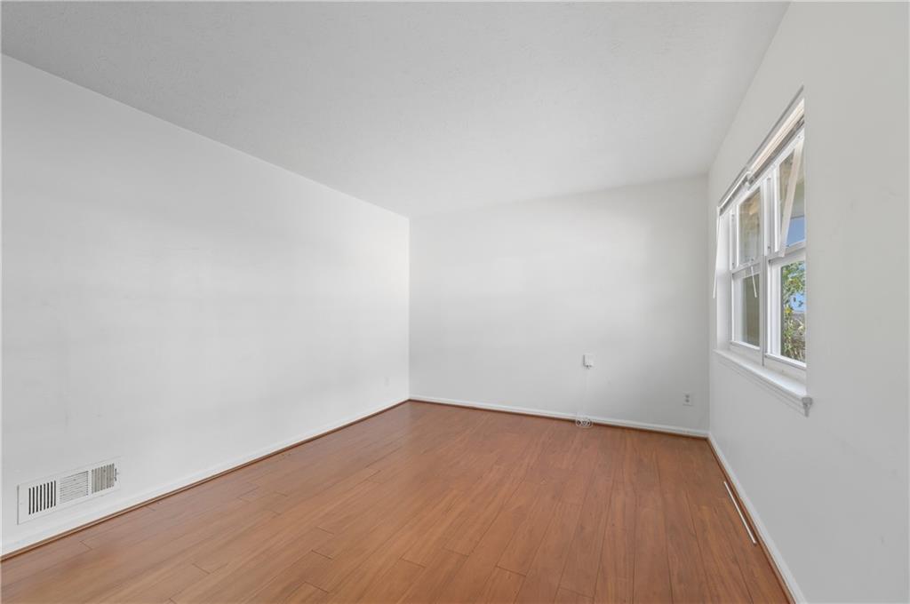 2139 Trailwood Road Decatur, GA 30032 - Photo 10 of 21 a view of an empty room with wooden floor and a window