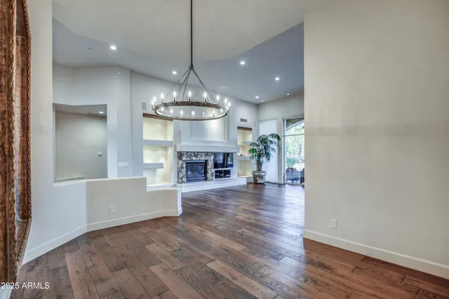 a view of a livingroom with an empty space and a window