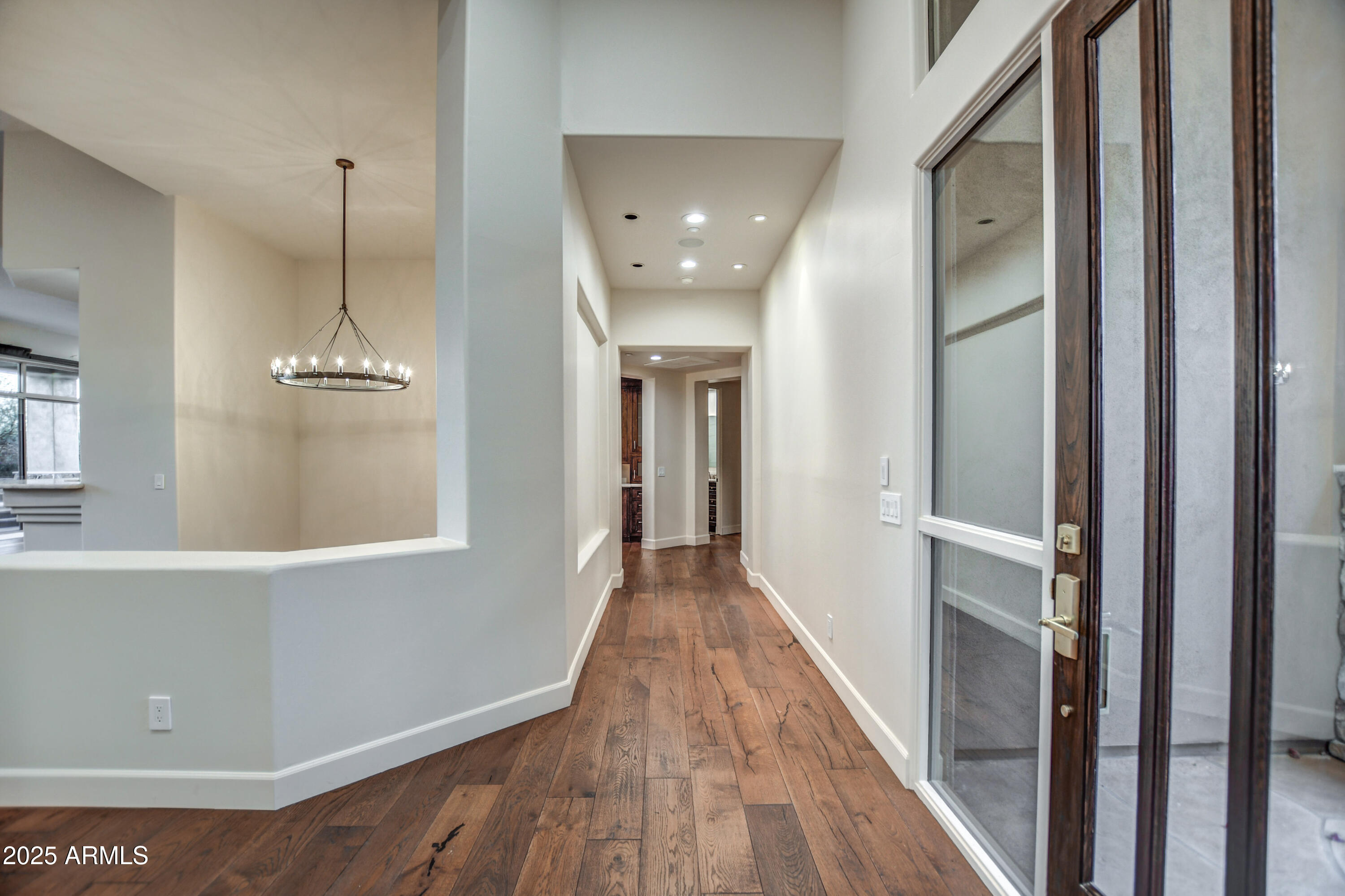 9671 East Monument Drive Scottsdale, AZ 85262 - Photo 11 of 124 a view of a hallway with wooden floor and staircase