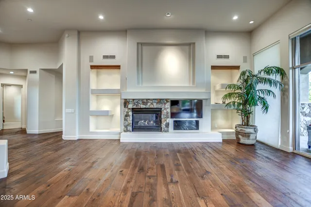a bedroom with a bed and a ceiling fan