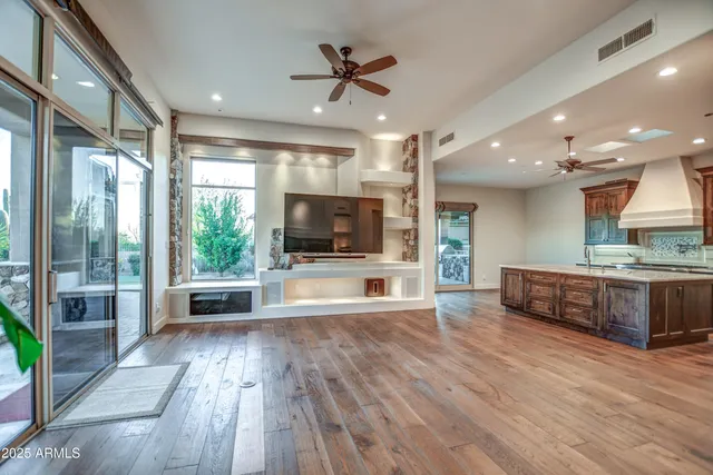 a view of empty room with wooden floor and floor to ceiling window