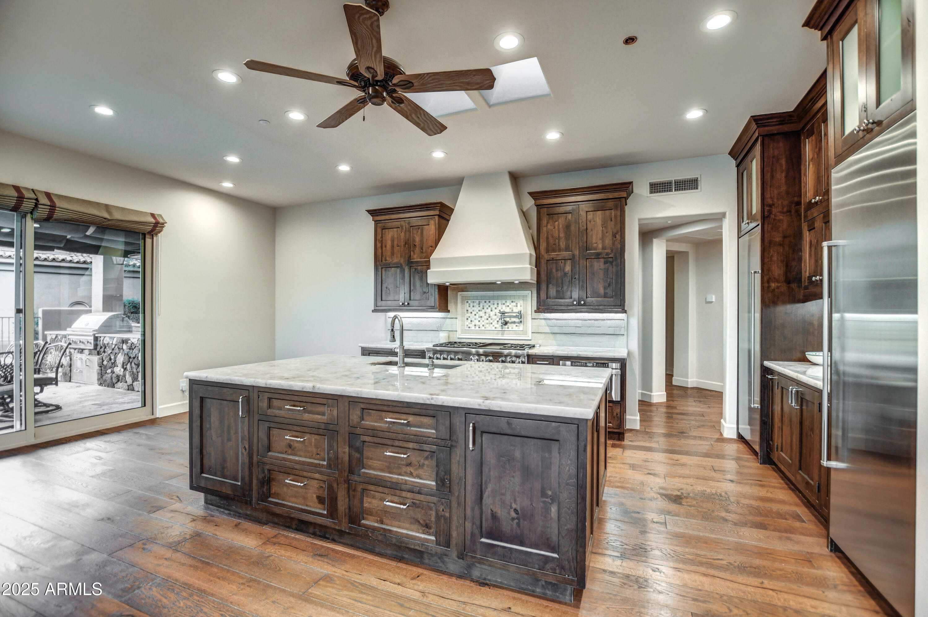9671 East Monument Drive Scottsdale, AZ 85262 - Photo 24 of 124 a kitchen with stainless steel appliances granite countertop a sink a stove and a refrigerator