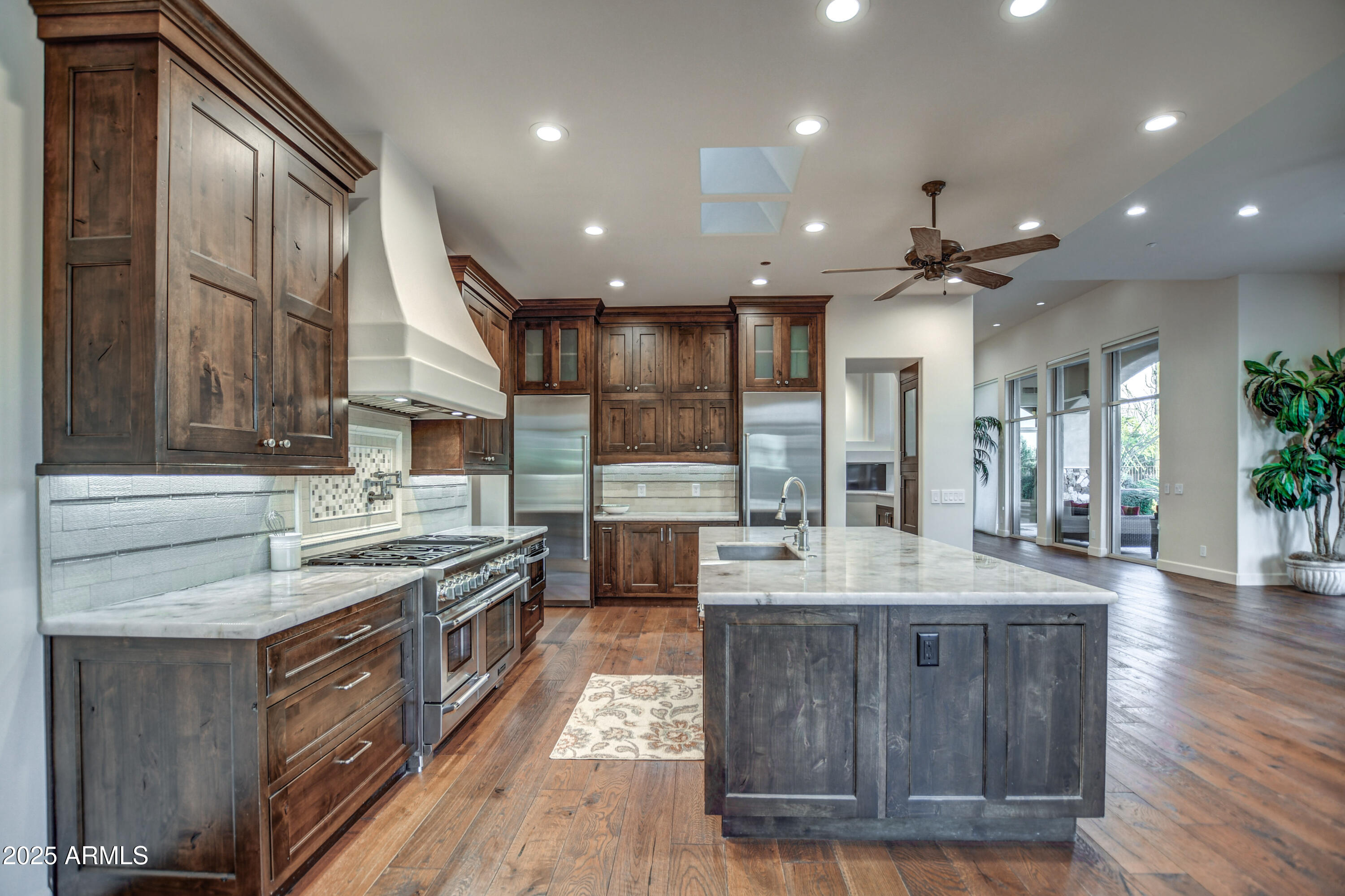 9671 East Monument Drive Scottsdale, AZ 85262 - Photo 25 of 124 an open kitchen with a sink and stove top oven