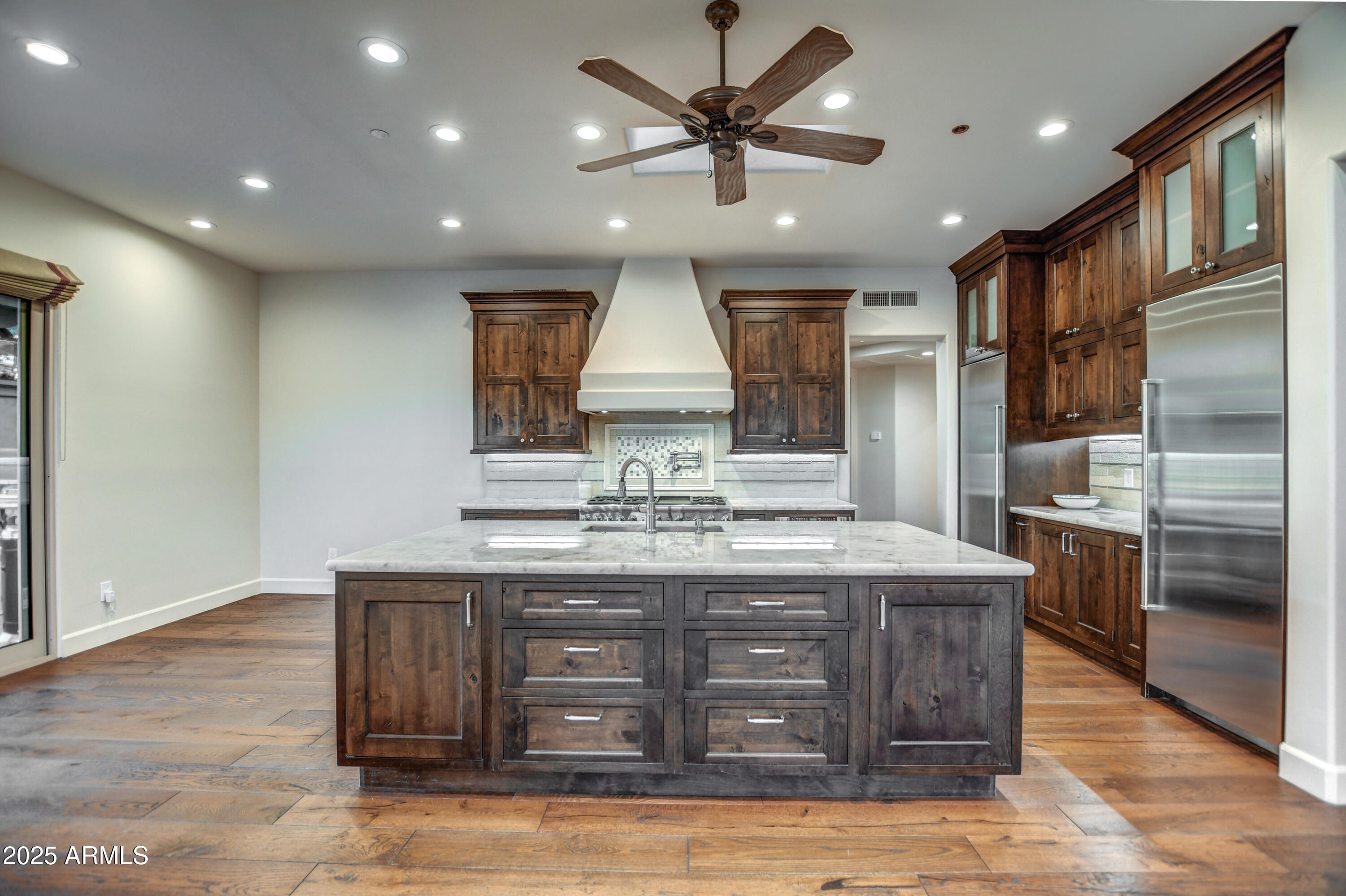 9671 East Monument Drive Scottsdale, AZ 85262 - Photo 29 of 124 a kitchen with kitchen island granite countertop a stove and a sink