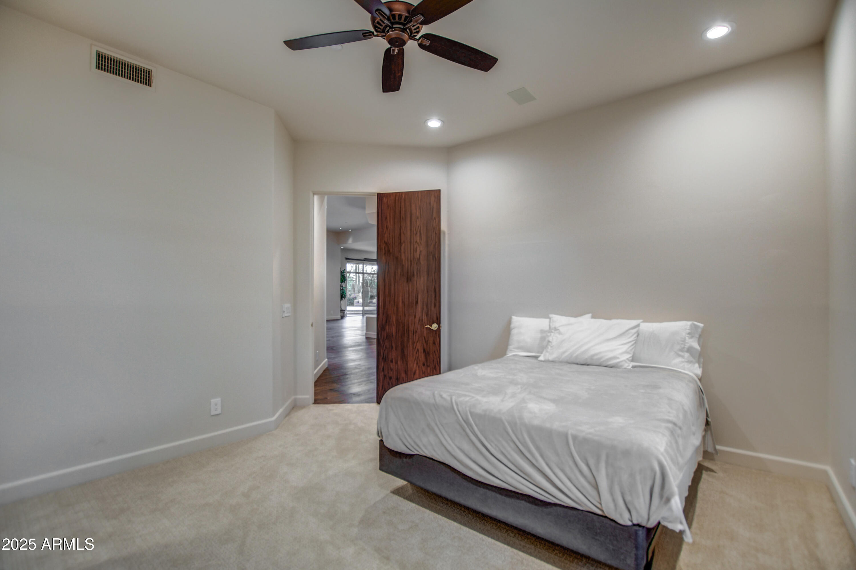 9671 East Monument Drive Scottsdale, AZ 85262 - Photo 43 of 124 a bedroom with a bed and a ceiling fan