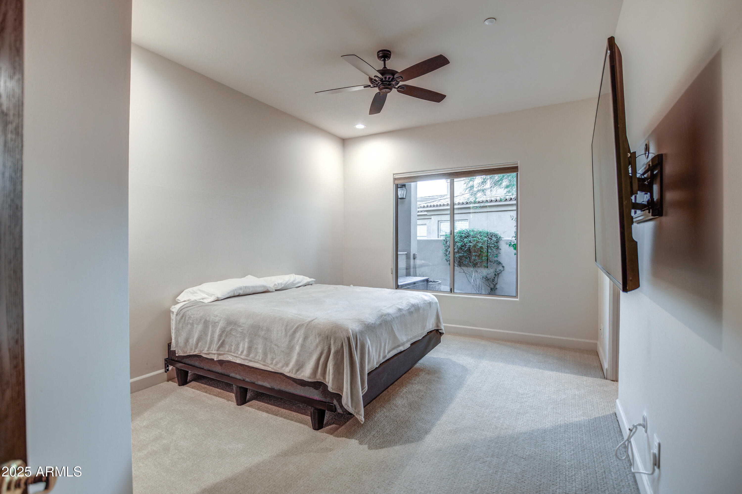 9671 East Monument Drive Scottsdale, AZ 85262 - Photo 44 of 124 a spacious bedroom with a bed and a window