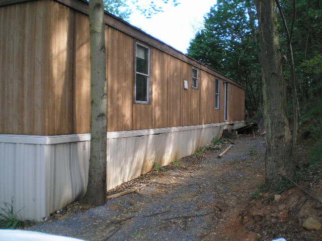 1086 Colonial Road Blue Ridge, VA 24064 - Photo 2 of 6 a backyard of a house with wooden fence