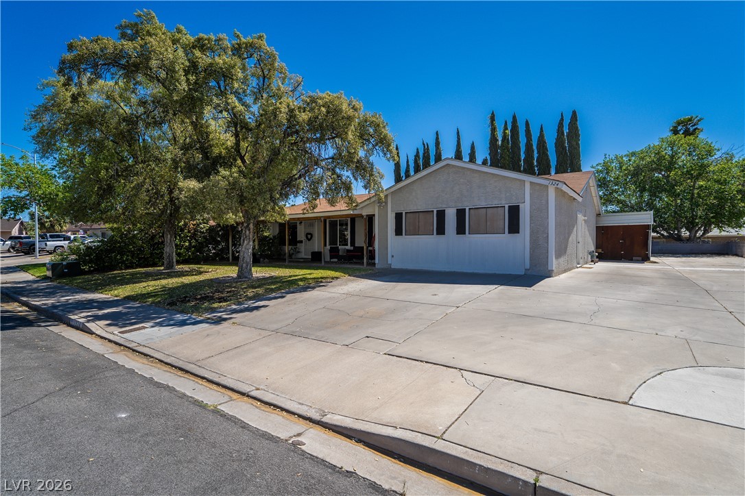 1324 Appaloosa Road Boulder City, NV 89005 - Photo 42 of 42 A classic ranch home, featuring a generous concrete driveway and a welcoming front yard with mature trees.