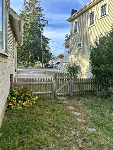 a green field with trees in the background