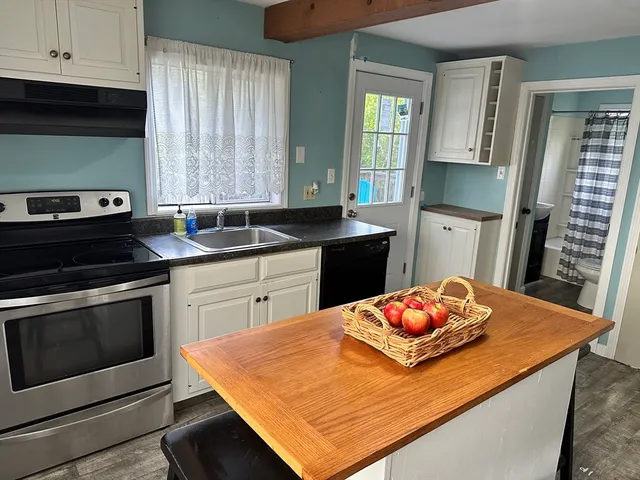 a kitchen with stainless steel appliances kitchen island granite countertop a sink dishwasher and stove