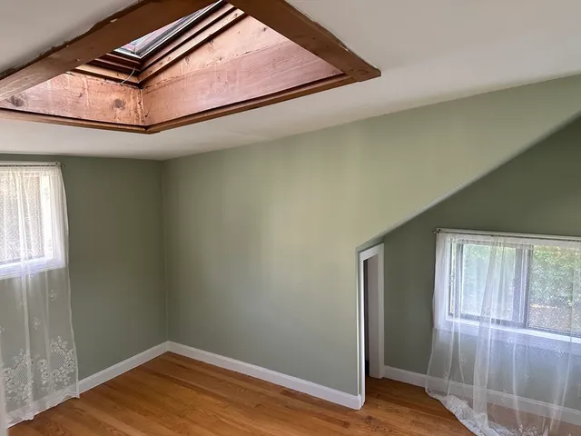 an empty room with wooden floor