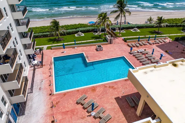 a view of swimming pool with outdoor seating and a patio