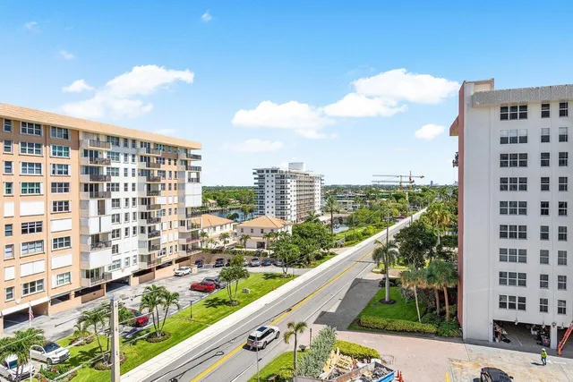 a city view from a balcony with outdoor seating