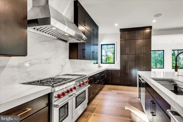 a kitchen with stainless steel appliances granite countertop a stove and a sink