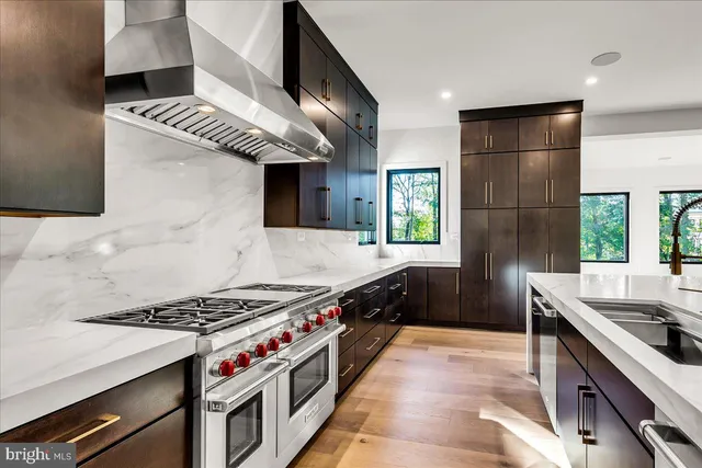 a kitchen with stainless steel appliances granite countertop a stove and a sink