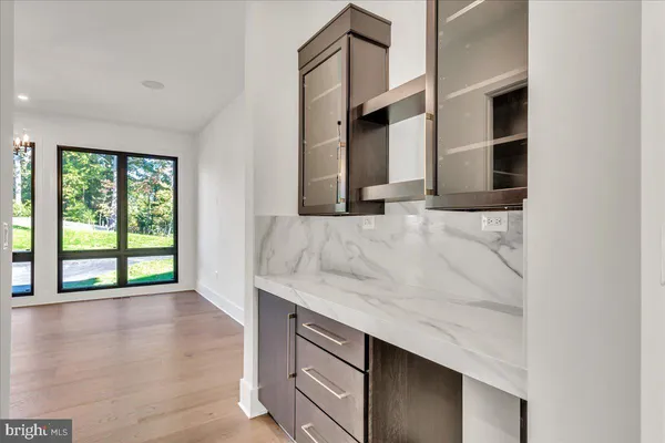 an entryway with wooden floor and windows
