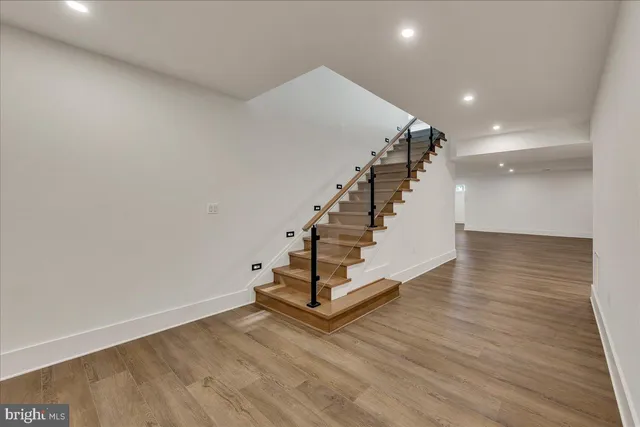 a view of entryway and hall with wooden floor