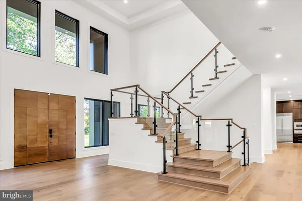 a view of entryway and hall with wooden floor