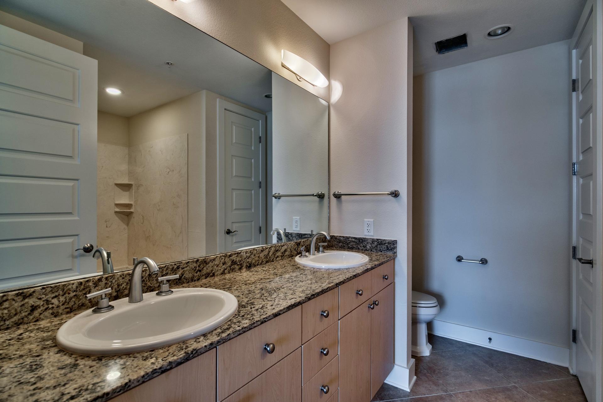 211 Durango Road, Unit 216 Destin, FL 32541 - Photo 16 of 35 a bathroom with a granite countertop sink and a mirror