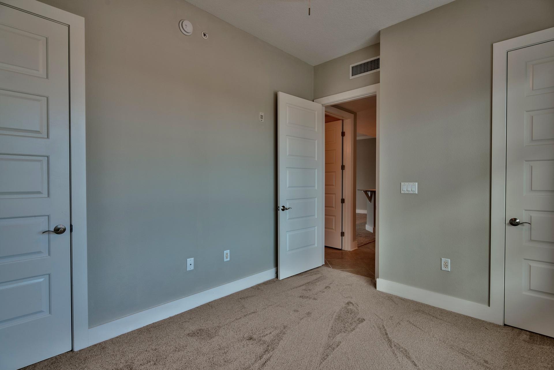 211 Durango Road, Unit 216 Destin, FL 32541 - Photo 20 of 35 a view of an empty room with closet and wooden door