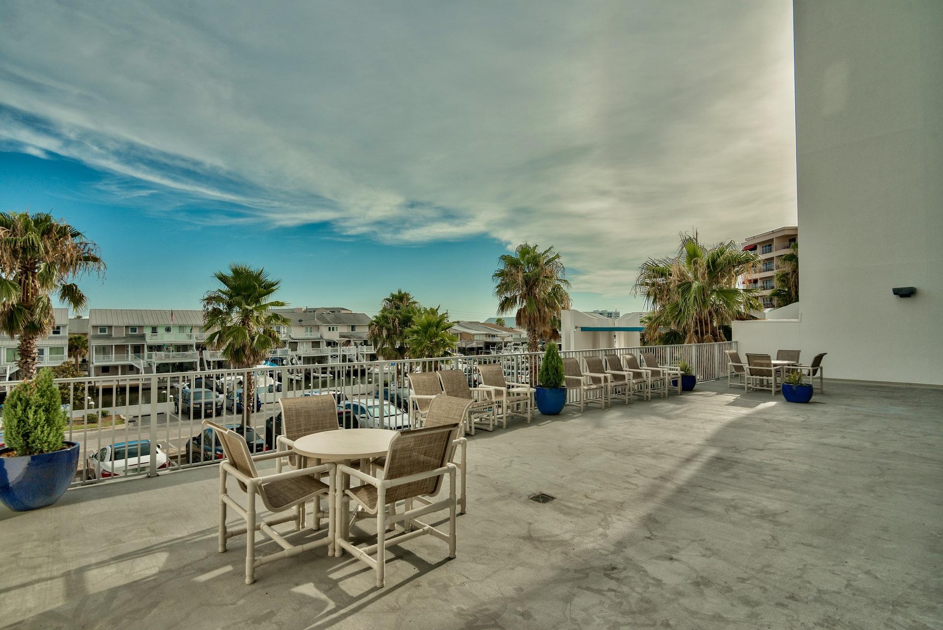 211 Durango Road, Unit 216 Destin, FL 32541 - Photo 23 of 35 a view of a chairs and tables in the patio