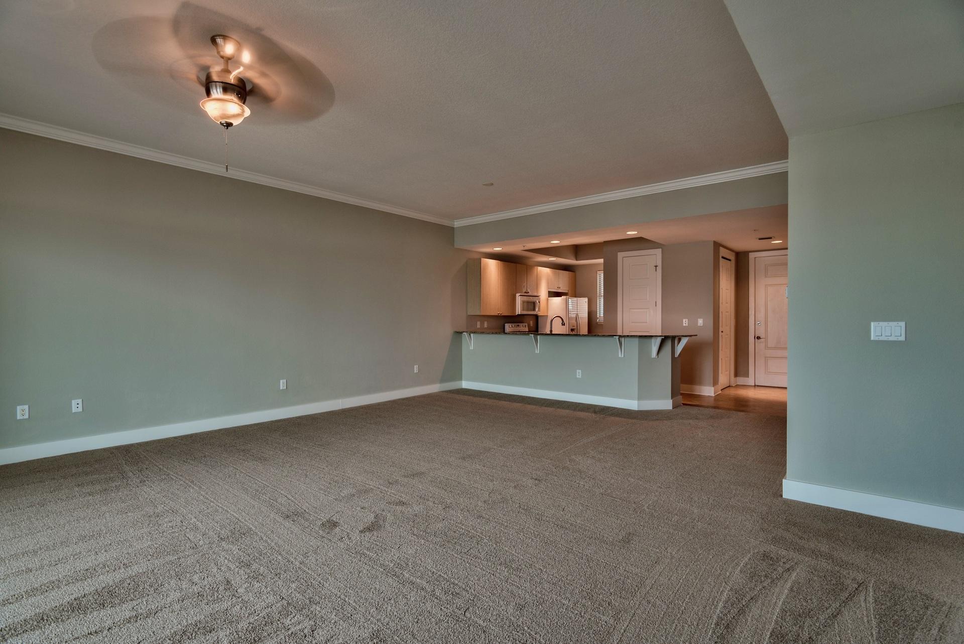 211 Durango Road, Unit 216 Destin, FL 32541 - Photo 6 of 35 an empty room with a fireplace and wooden floor