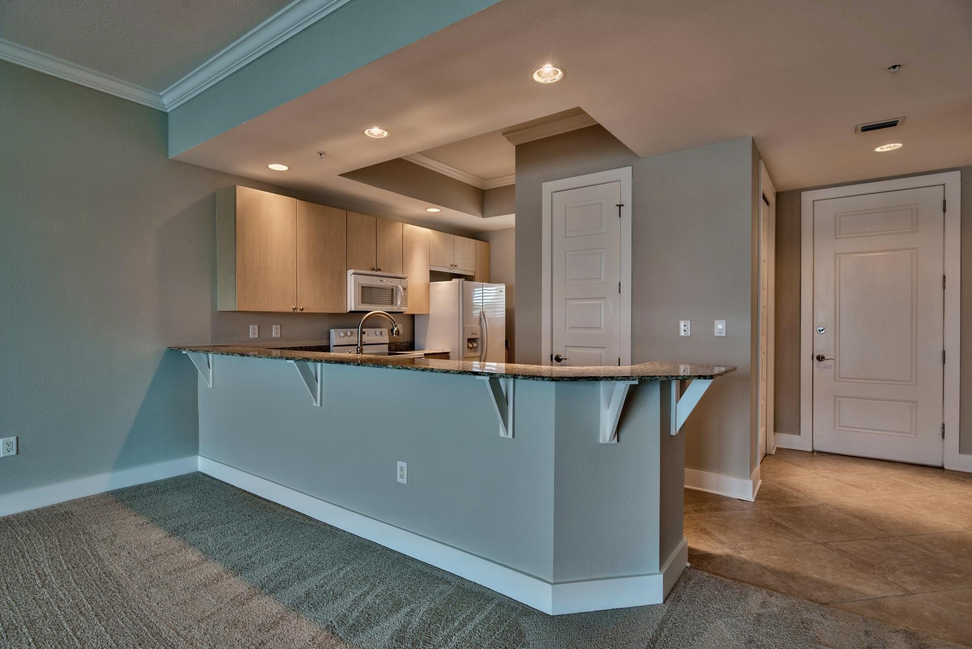 211 Durango Road, Unit 216 Destin, FL 32541 - Photo 8 of 35 a kitchen with stainless steel appliances granite countertop a stove a sink and a refrigerator