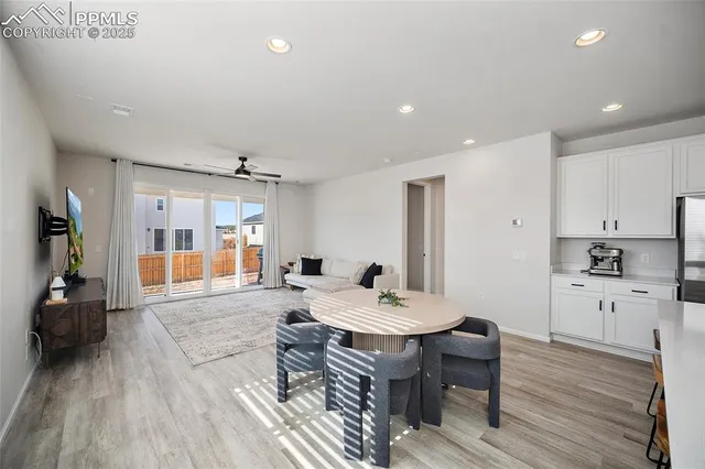 a large white kitchen with a table and chairs