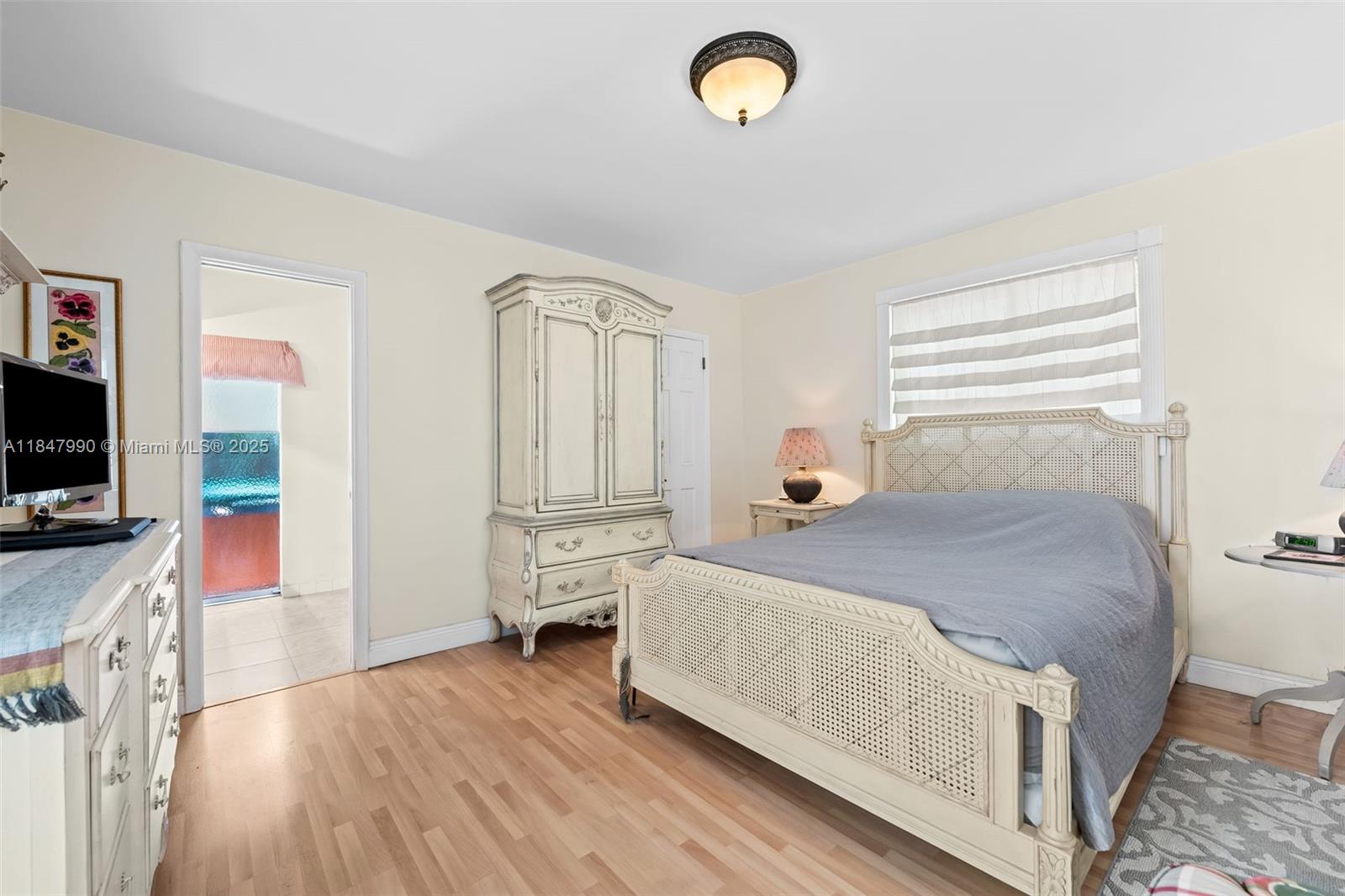 5414 West Park Road Hollywood, FL 33021 - Photo 14 of 19 a bedroom with a bed and wooden floor