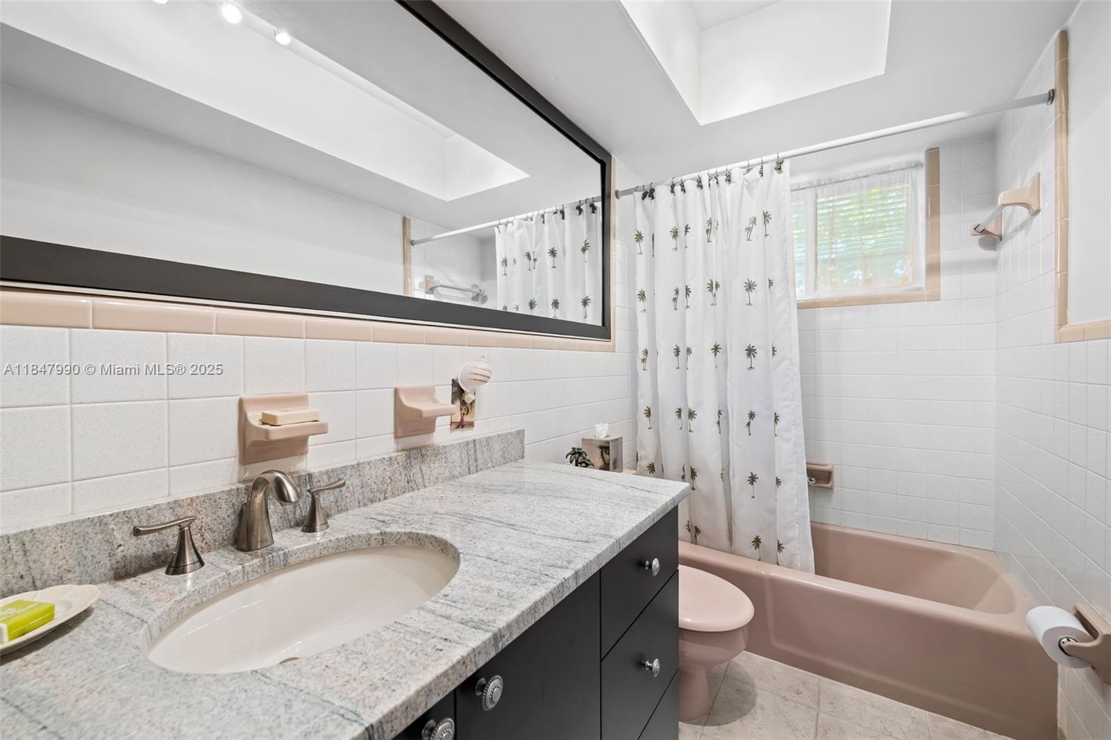 5414 West Park Road Hollywood, FL 33021 - Photo 18 of 19 a bathroom with a granite countertop sink a toilet a mirror a bathtub and shower