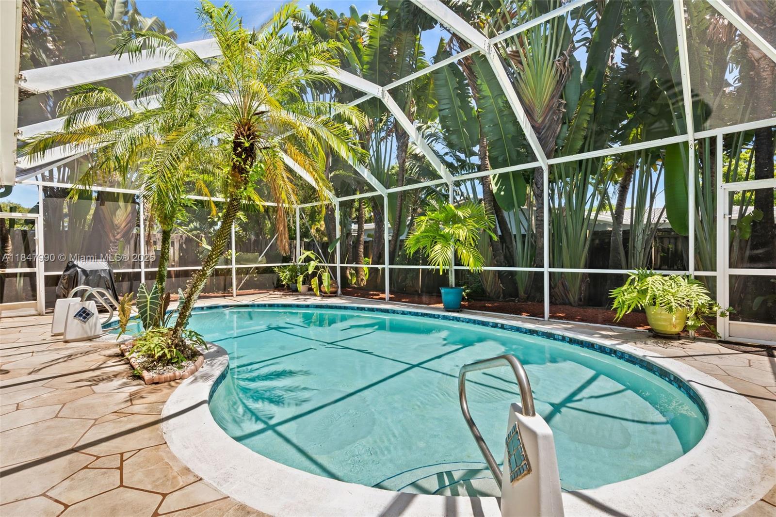 5414 West Park Road Hollywood, FL 33021 - Photo 4 of 19 a view of a swimming pool with potted plants
