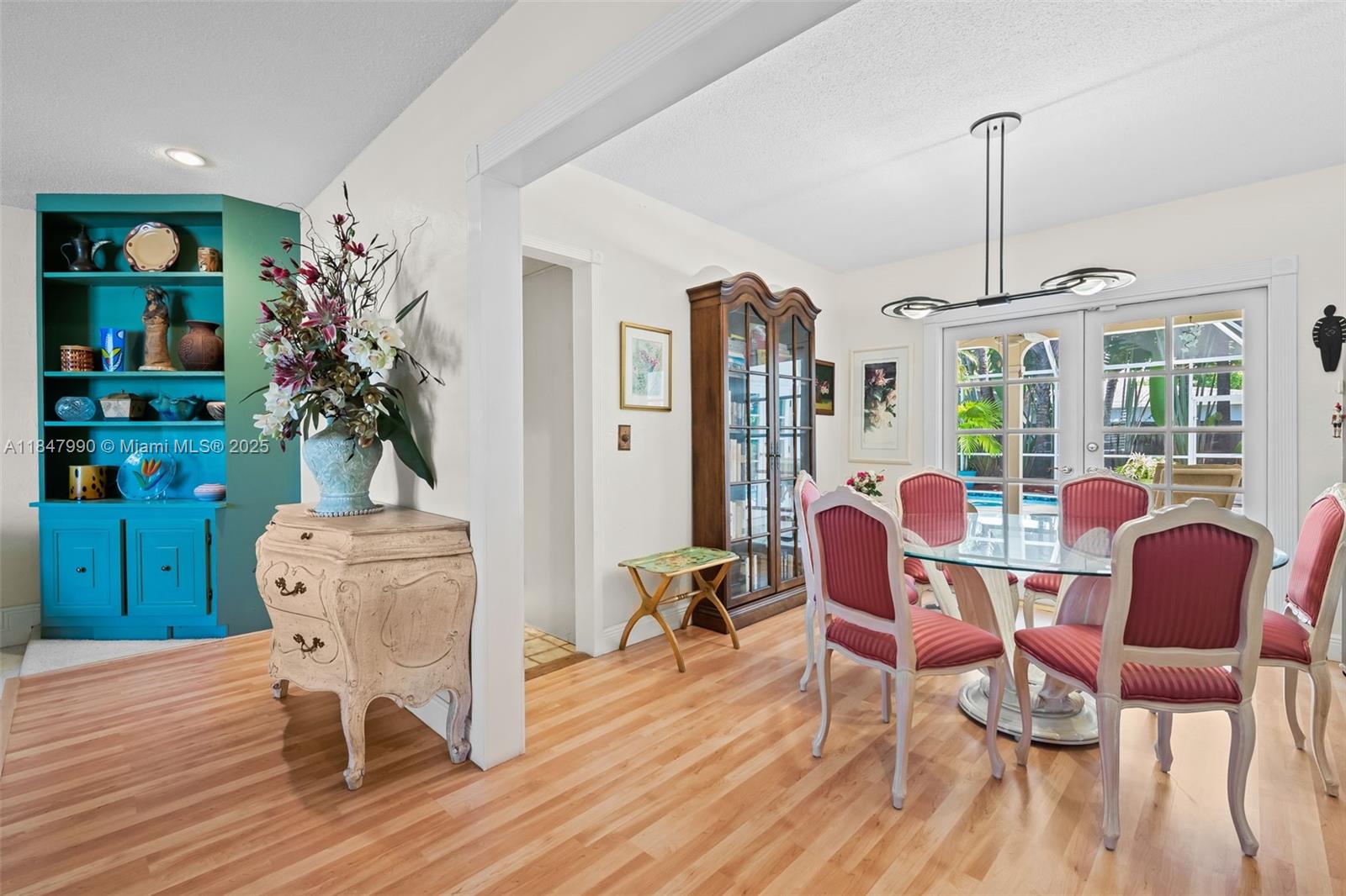 5414 West Park Road Hollywood, FL 33021 - Photo 10 of 19 a dining room with furniture a chandelier and wooden floor