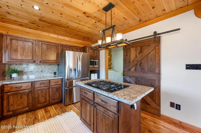 a kitchen with stainless steel appliances granite countertop a stove a sink and dishwasher