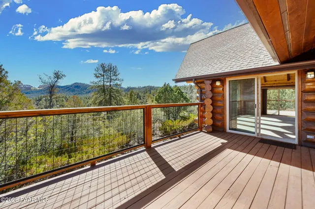 a view of a yard with plants and trees