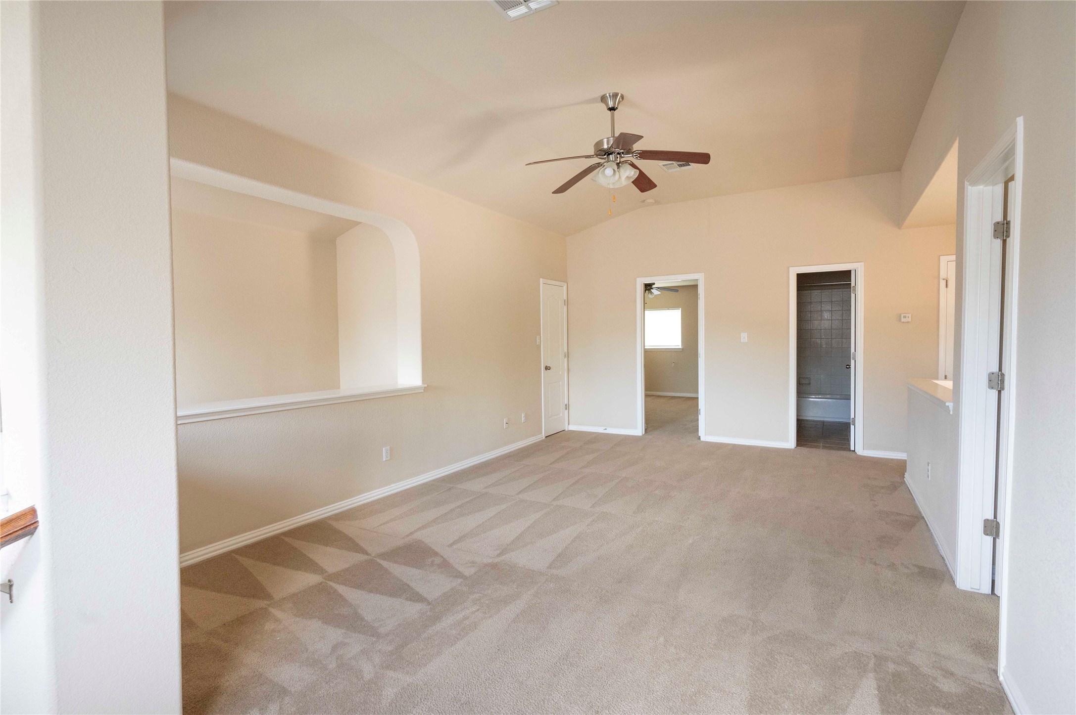 2070 Intrepid Drive Buda, TX 78610 - Photo 20 of 31 Well-lit living area with vaulted ceilings and plush carpet, ready for your personal touch.