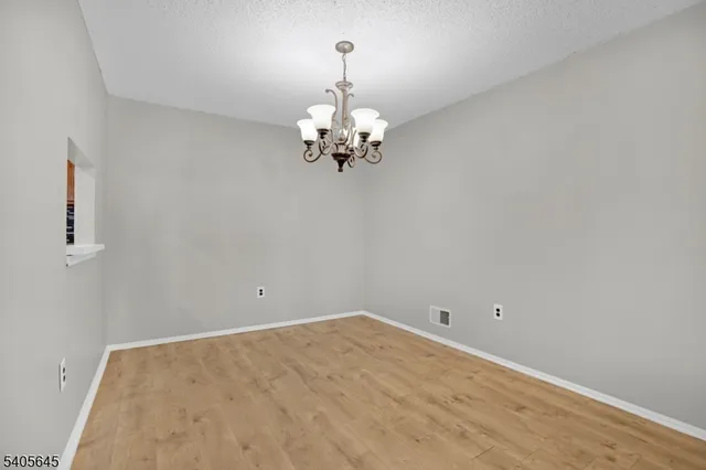 a view of a chandelier fan and a wooden floor
