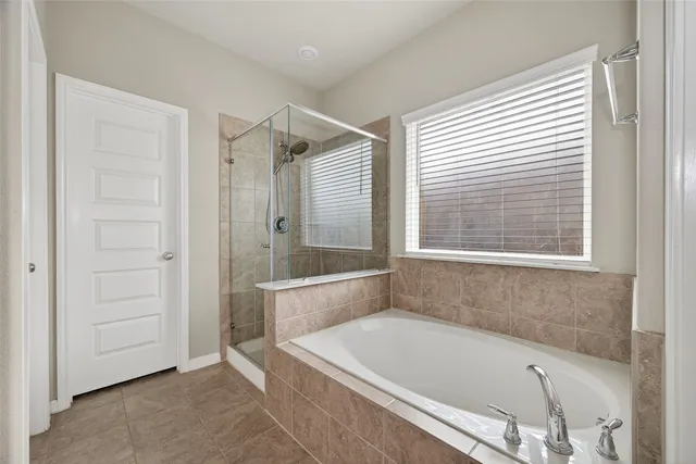 a bathroom with a tub and a shower