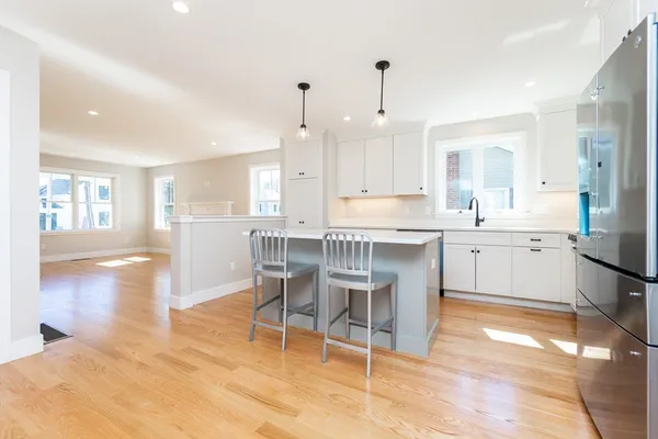a large kitchen with a table and chairs
