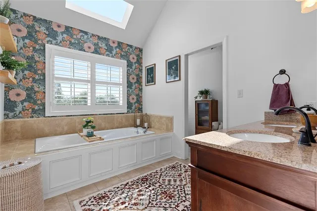 a bathroom with a double vanity sink and a mirror