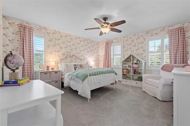 a bathroom with a granite countertop toilet sink and mirror