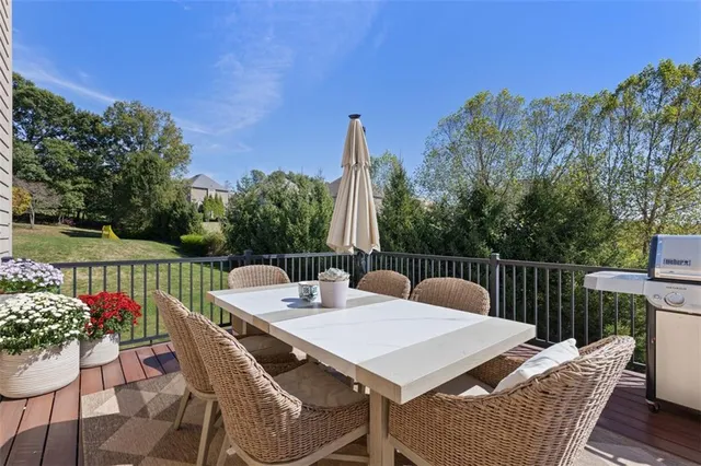a living room with patio furniture and a floor to ceiling window