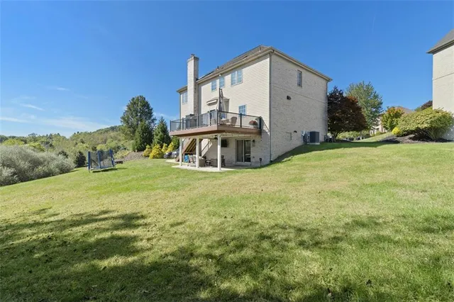 a view of a house with backyard sitting area and garden