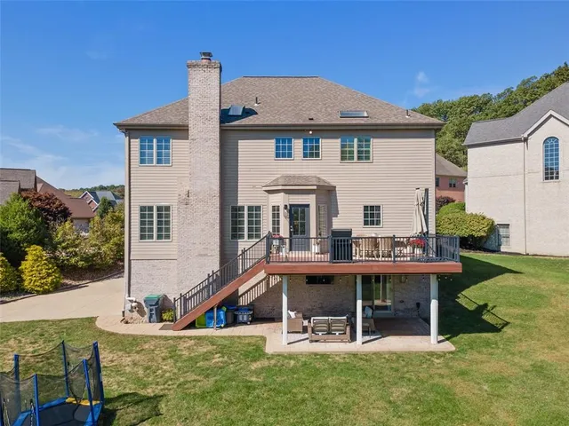 an aerial view of a house with a swimming pool and outdoor seating
