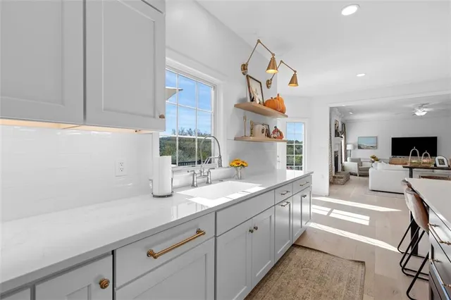 a kitchen with sink a counter and cabinets