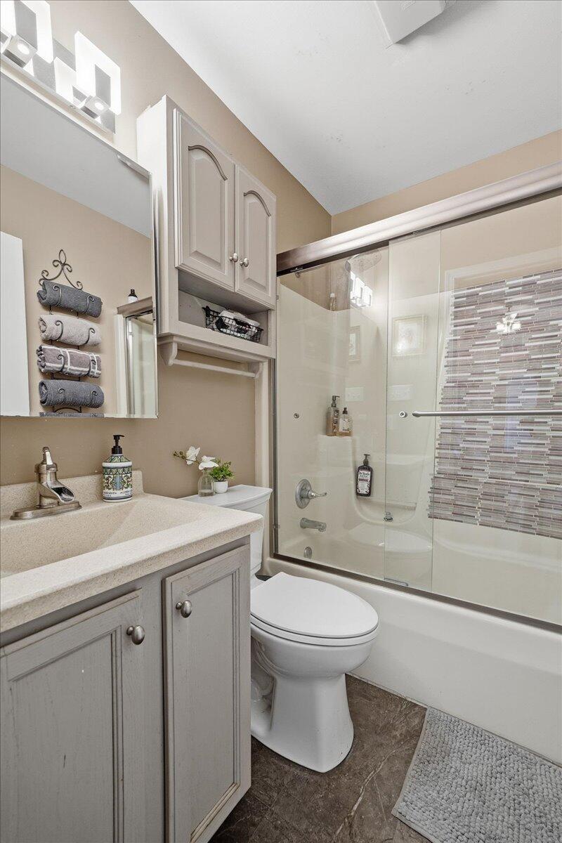 2258 Iris Street Portage, IN 46368 - Photo 19 of 29 a bathroom with a sink a toilet and shower