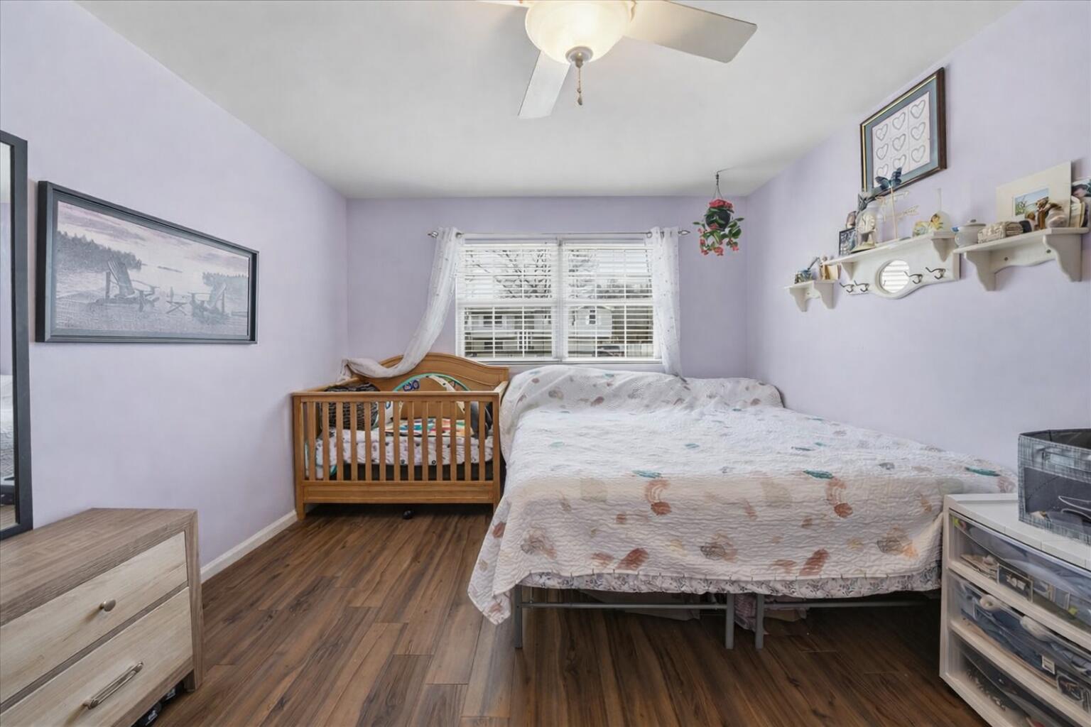 2258 Iris Street Portage, IN 46368 - Photo 7 of 29 a bedroom with a bed and wooden floor