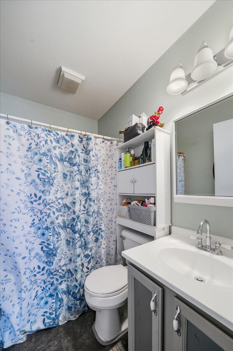 2258 Iris Street Portage, IN 46368 - Photo 9 of 29 a bathroom with a sink a toilet and a mirror