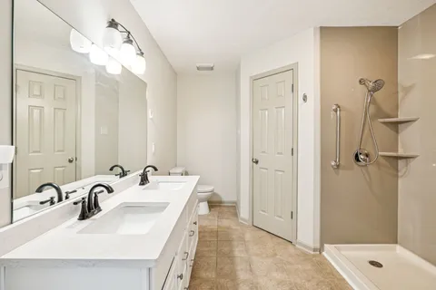 a bathroom with a sink toilet and mirror