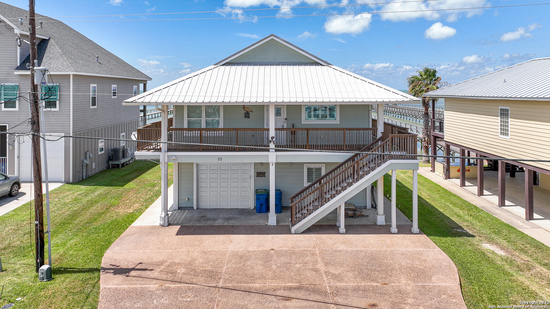 70 Copano Ridge Road Rockport, TX 78382 - Photo 1 of 1 a view of a house with wooden stairs and a yard