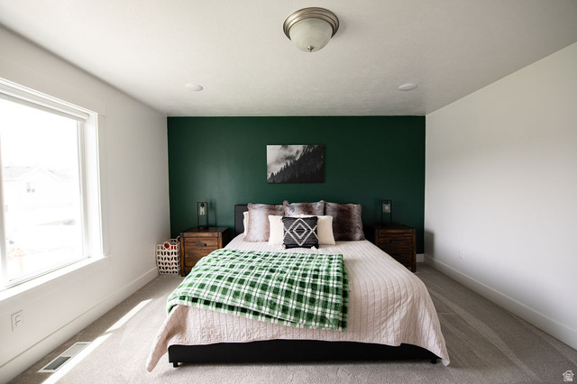 384 Ropelato Drive Nibley, UT 84321 - Photo 11 of 25 Carpeted bedroom with baseboards and an accent wall